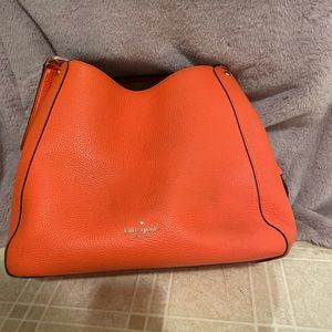 Orange Kate Spade 3-pocket pebbled leather purse